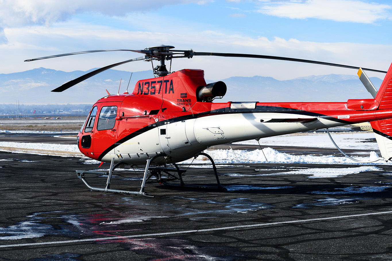 An Airbus Helicopters AS350 B3 sits on a helipad